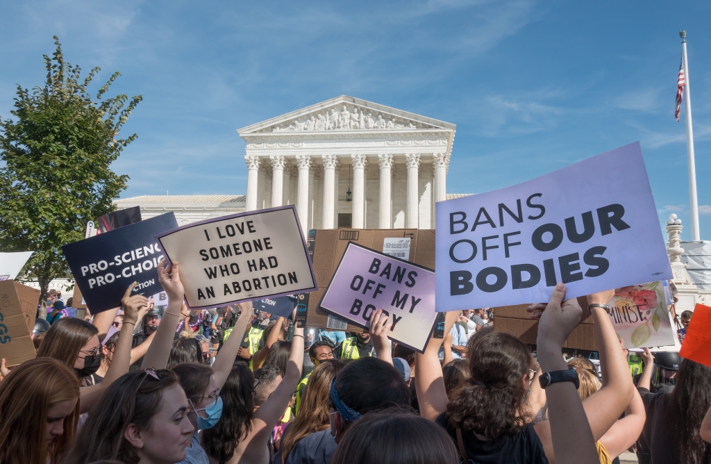 Protesters outside the US Supreme Court holding placards that read I love someone who had an abortion, bans off my body and pro-science, pro-choice